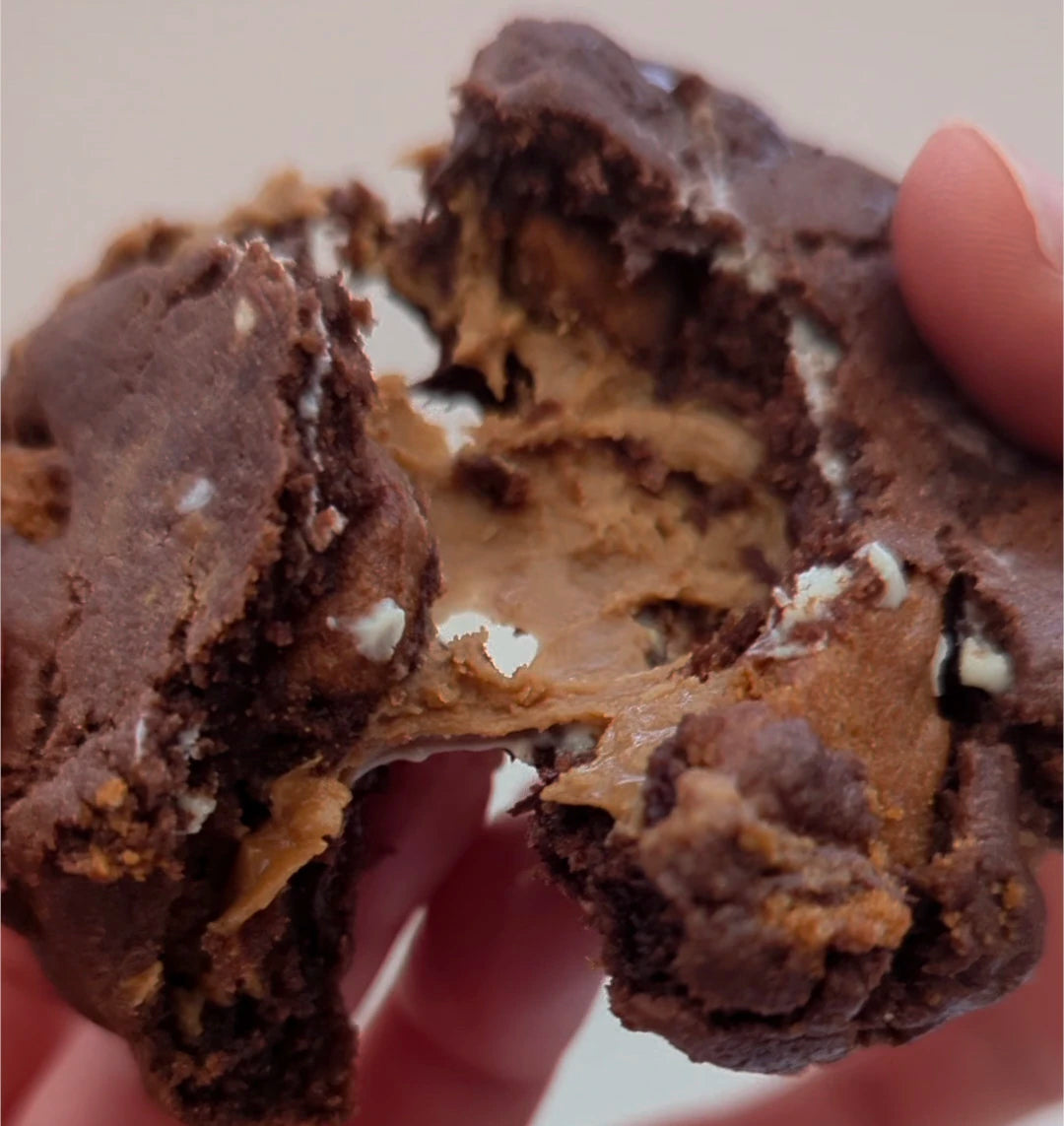 Biscoff Cookie being torn apart revealing gooey center